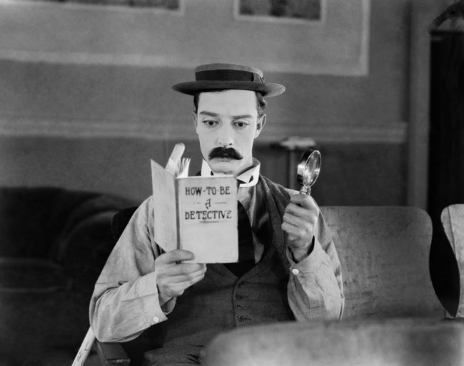 1924: American comedian Buster Keaton (1895-1966) armed with only a magnifying glass and a copy of 'How To Be A Detective' hopes to become a great detective in the film 'Sherlock Junior'.